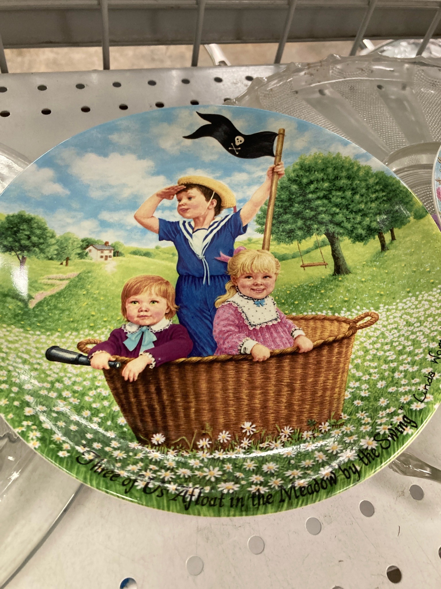 Submitted photo of Decorative collector plate featuring children in a basket, signed 'Linda Wright' (not authenticated)
