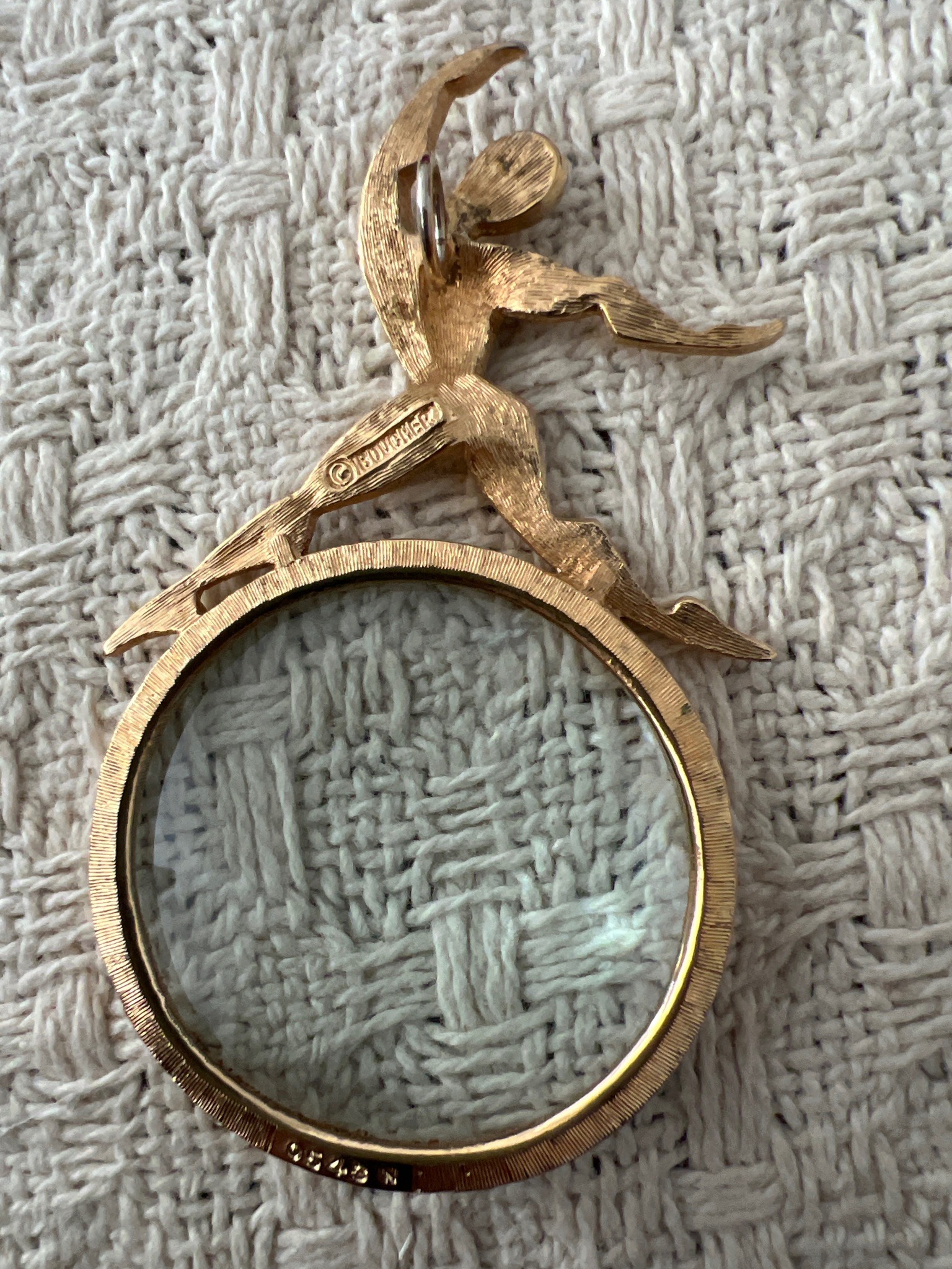 Submitted photo of Gold tone magnifying glass pendant, bears the mark 'BOUCHER' (not authenticated)