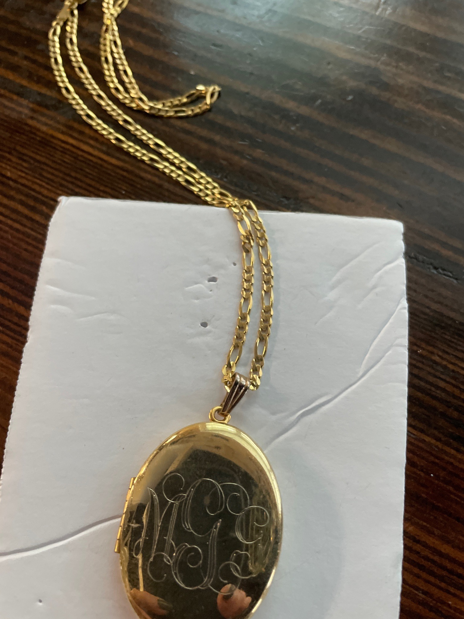 Submitted photo of Gold-tone locket necklace with monogram
