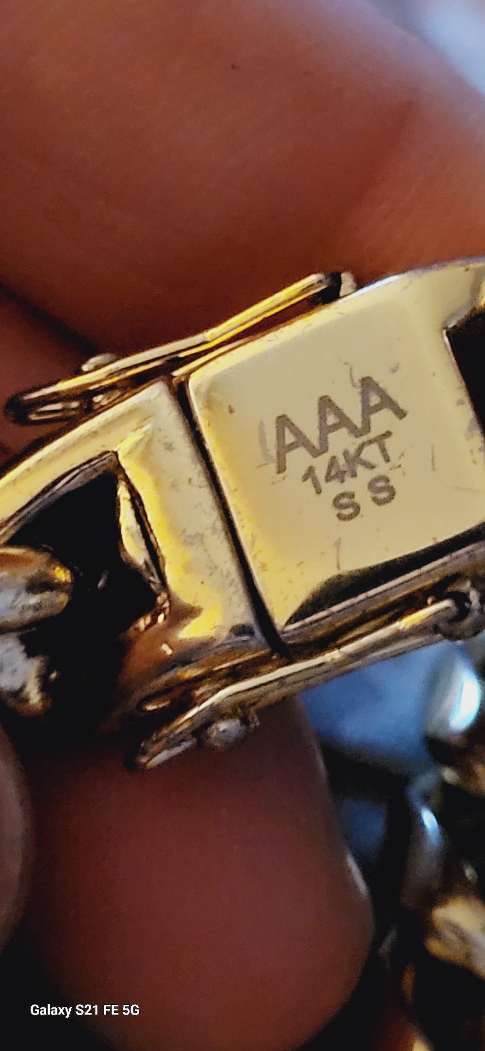 Submitted photo of Gold-toned jewelry clasp with markings (not authenticated)