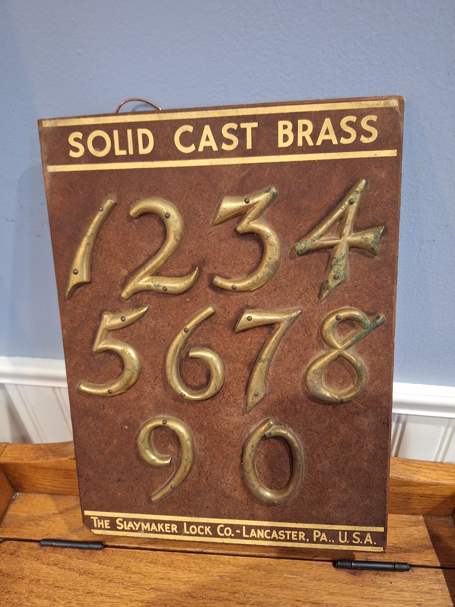Submitted photo of Brass numbers salesman sample display board, marked 'The Slaymaker Lock Co. - Lancaster, Pa., U.S.A.' (not authenticated)