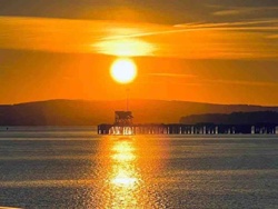 Sunset over Water with Pier