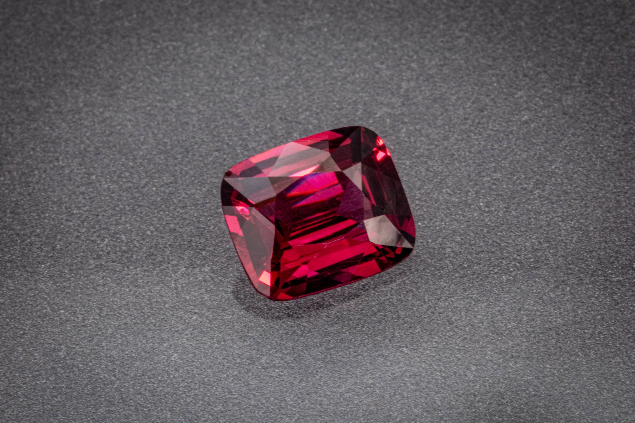 Submitted photo of Cushion cut reddish-pink gemstone
