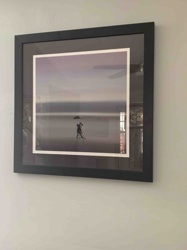 Framed Photograph: Couple with Umbrella on a Seashore