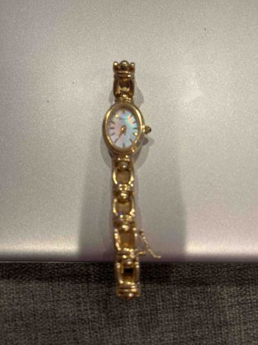 Women's Gold-Tone Oval Dial Wristwatch with Mother-of-Pearl Face and Intricate Bracelet Band