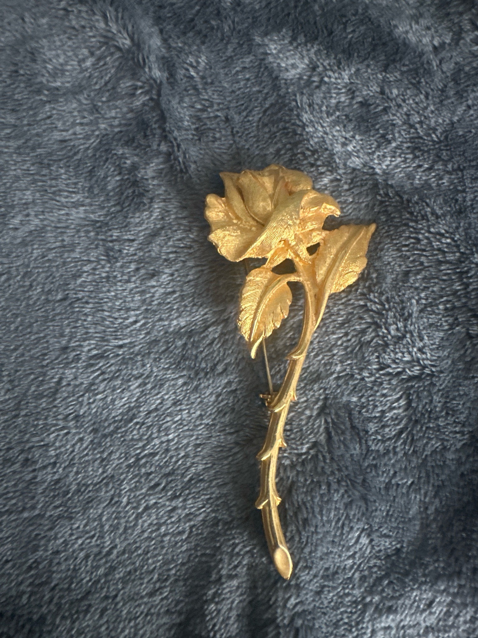 Submitted photo of Gold-tone metal rose brooch