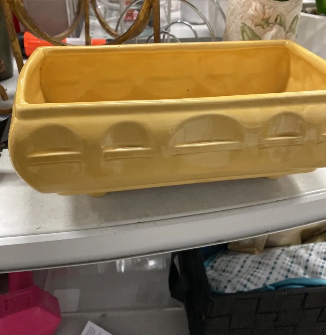 Submitted photo of Yellow ceramic planter with molded arch design