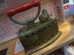 Antique Charcoal Iron with Red Wooden Handle and Squirrel Ornament