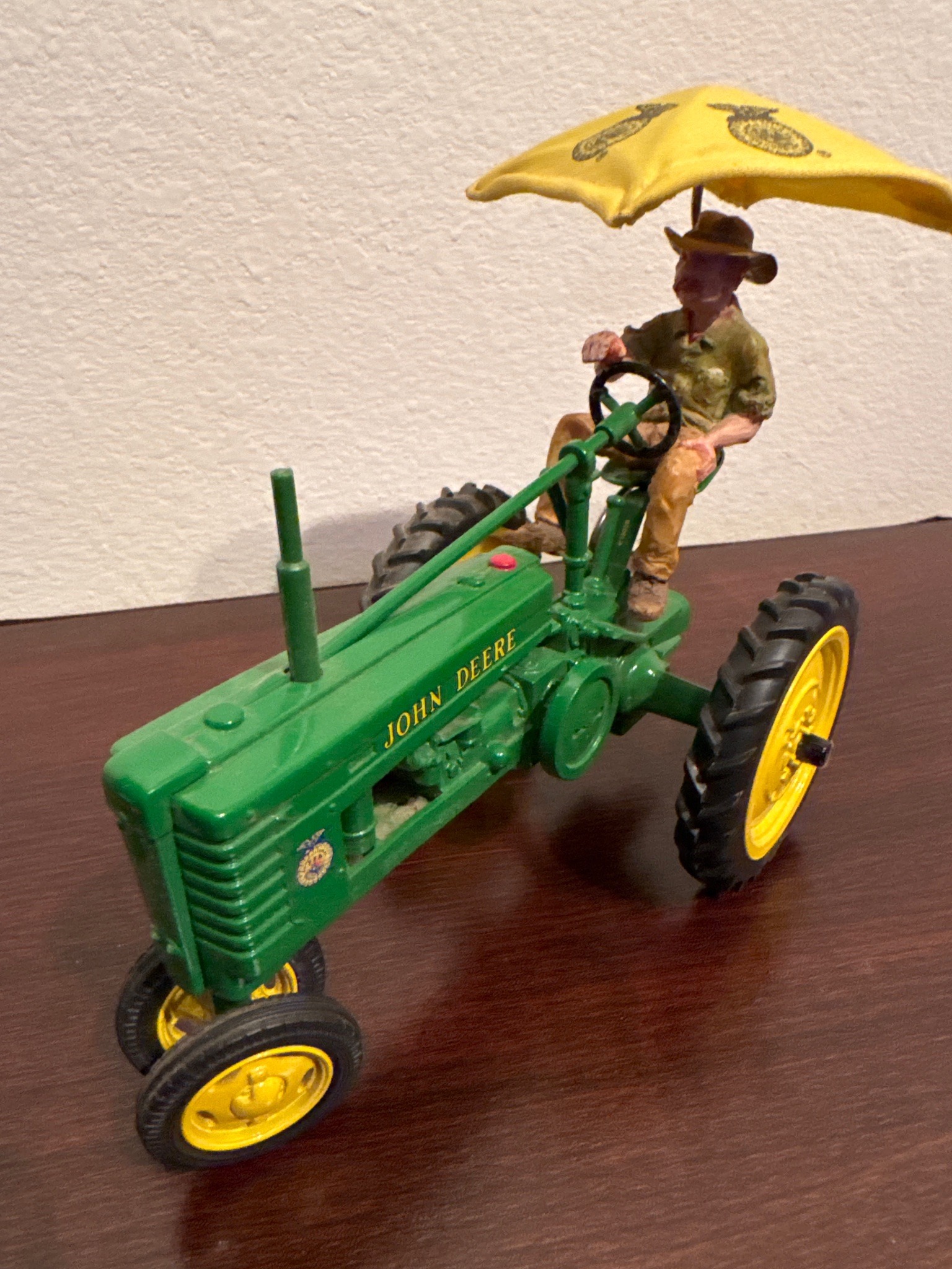 Submitted photo of John Deere toy tractor with figure and umbrella (not authenticated)