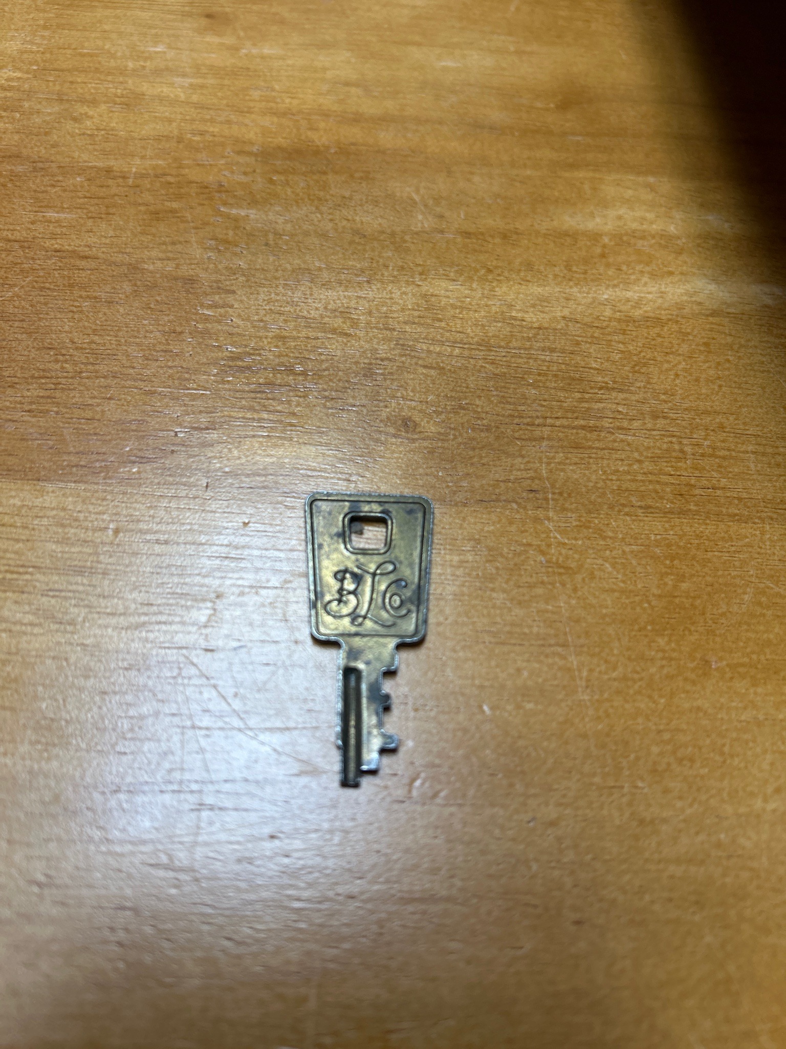 Submitted photo of Brass key with stamped monogram