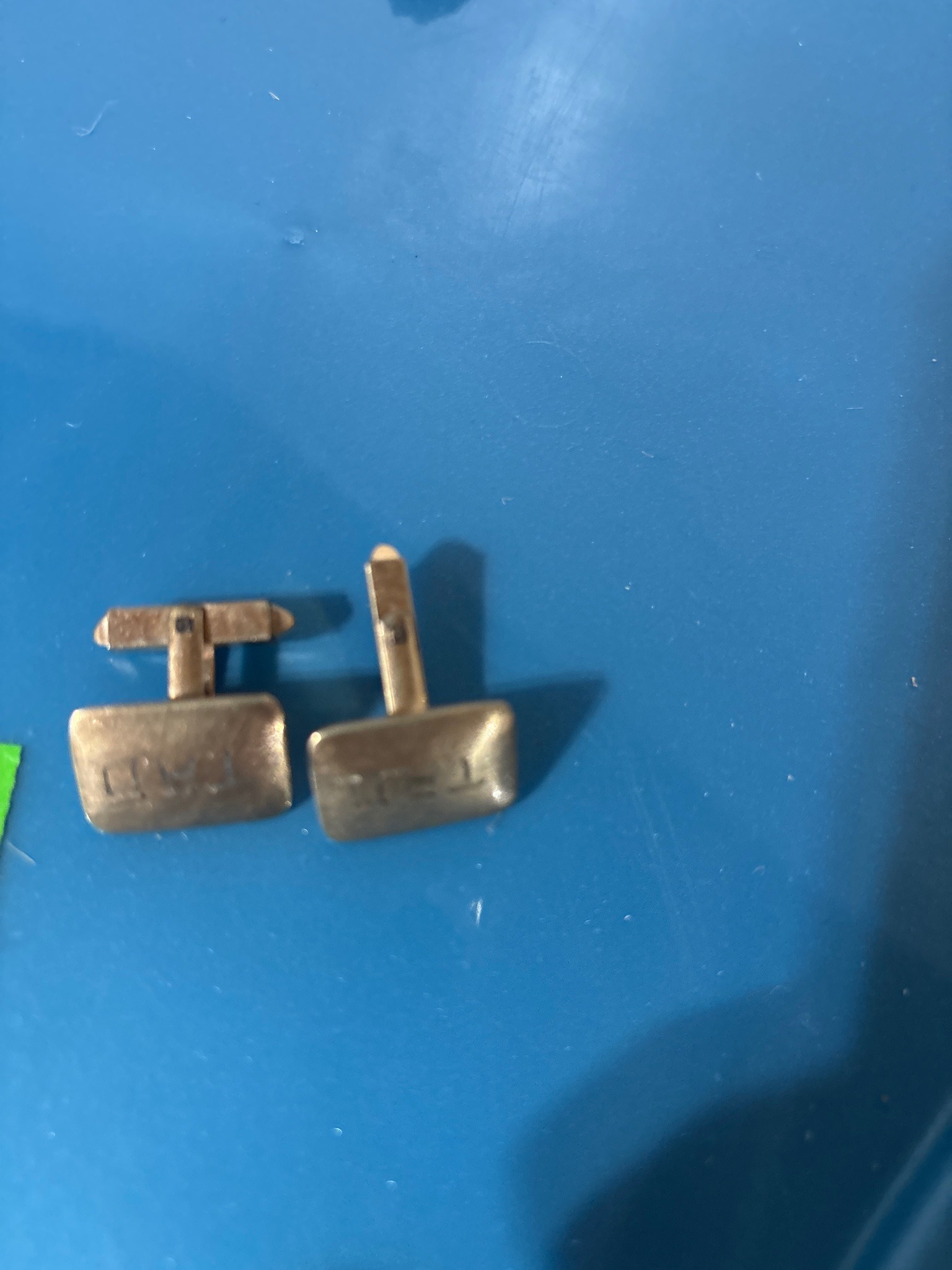Submitted photo of Gold-tone metal cufflinks bearing initials