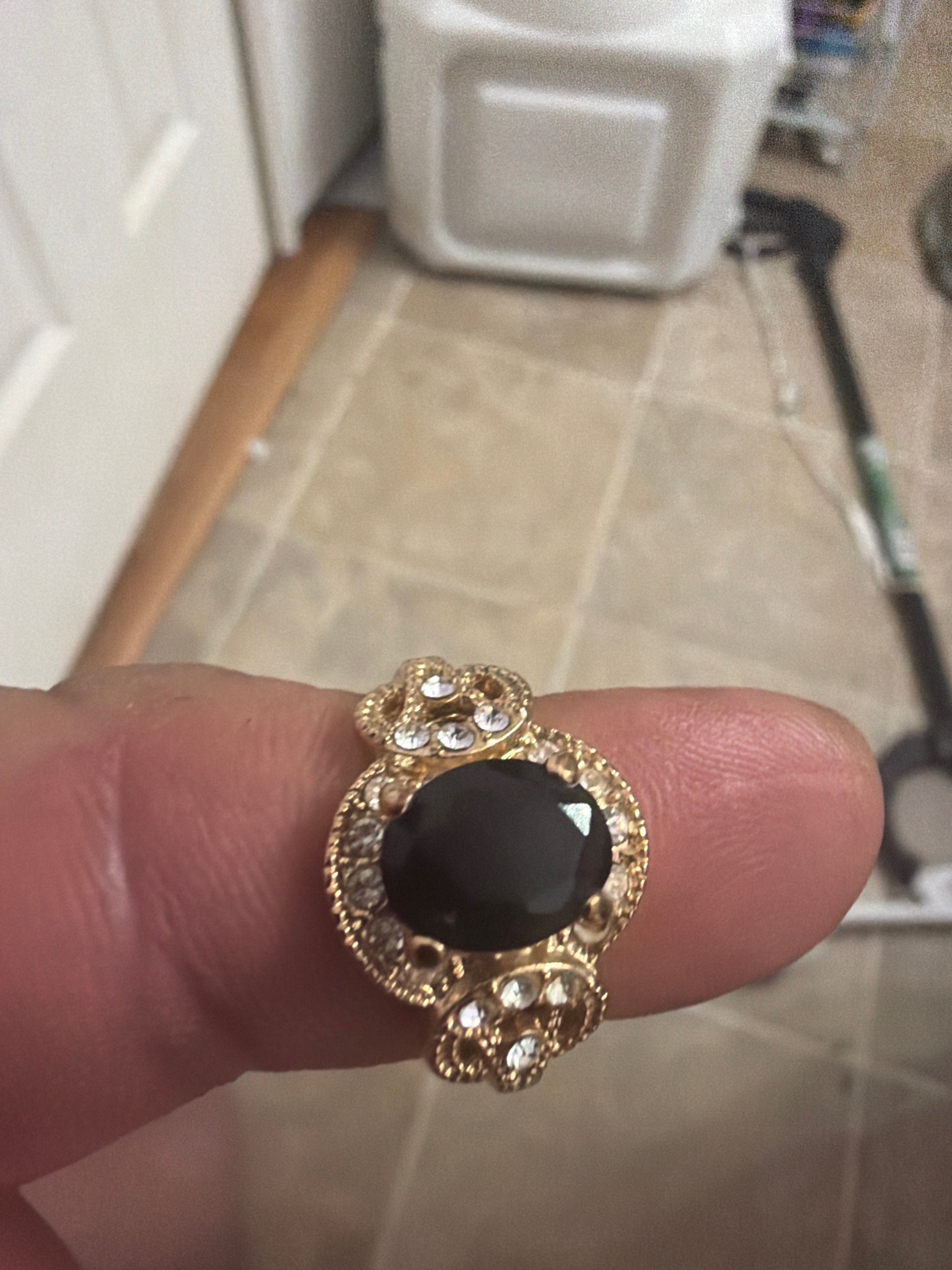 Submitted photo of Gold-tone costume ring with black center stone and pavé rhinestones