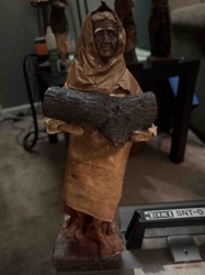 Figural Sculpture of a Woman Carrying Wood