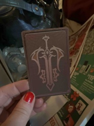 Collectible Card with Sword and Wing Design