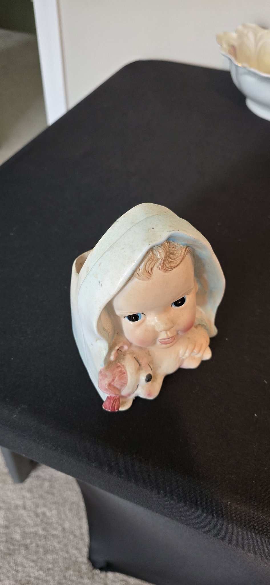 Submitted photo of Ceramic head vase depicting a child with a small animal