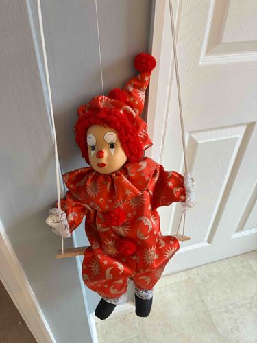 Clown Doll on Wooden Swing