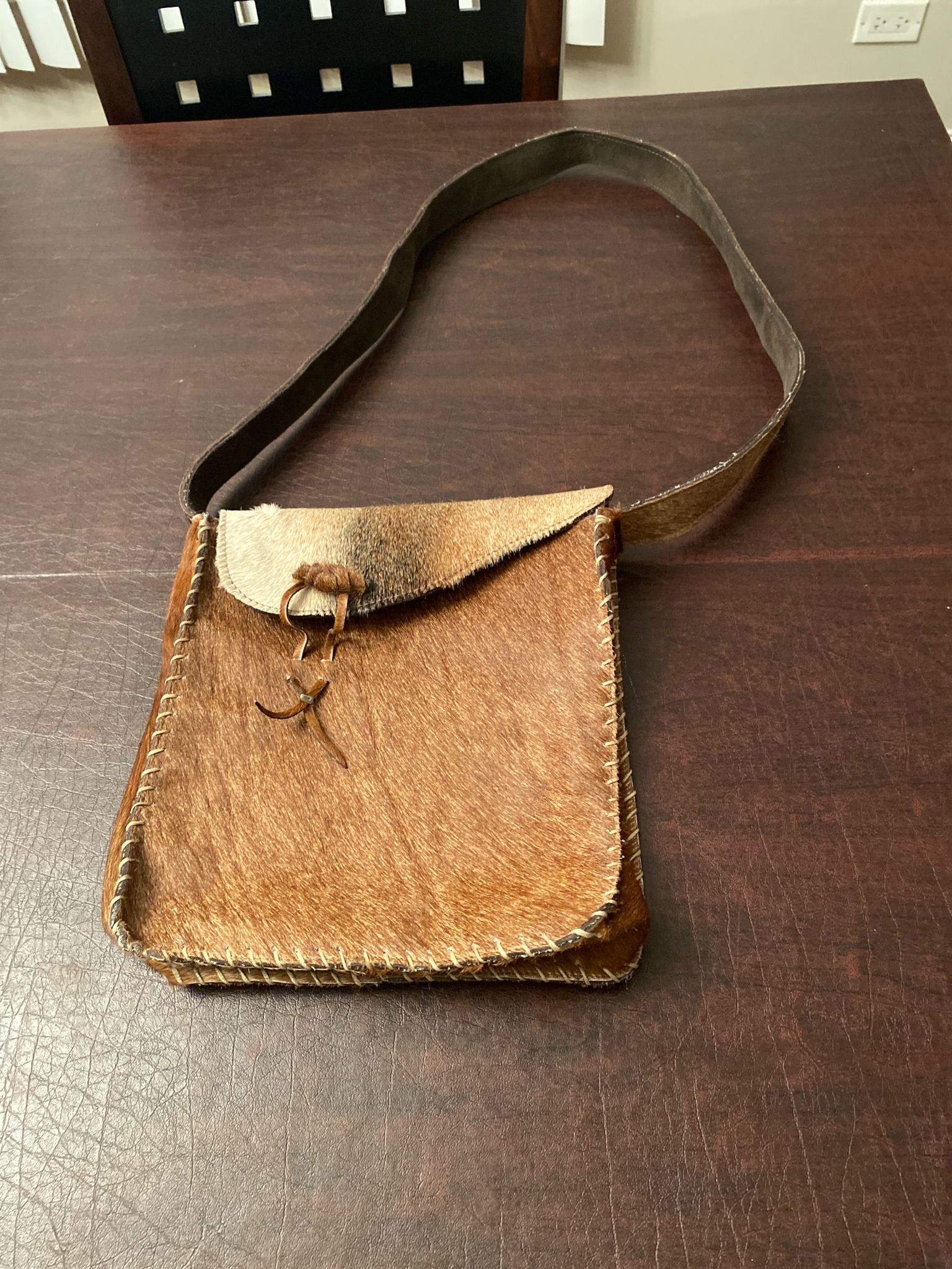 Submitted photo of Handmade leather shoulder bag with calf hair exterior