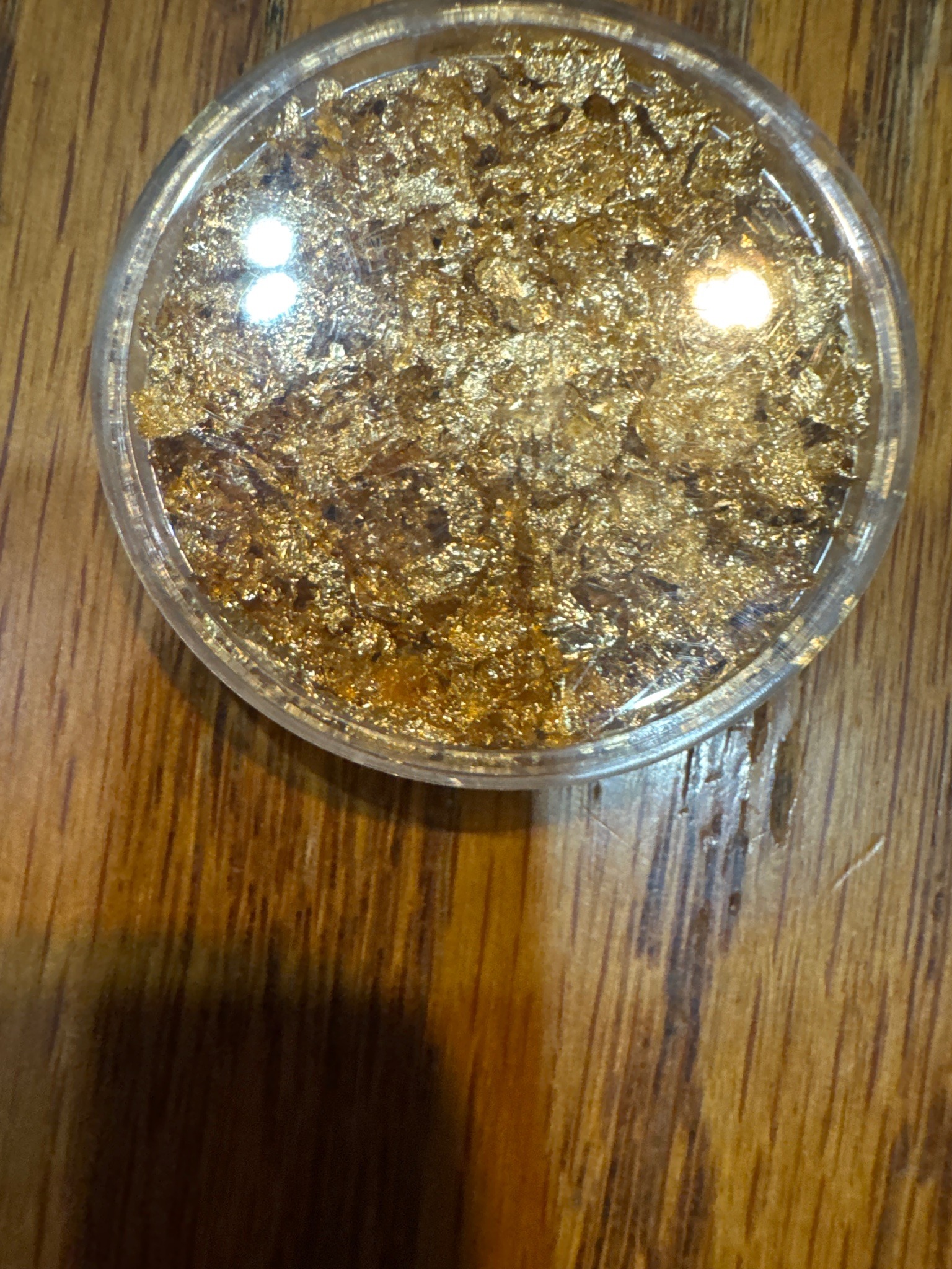 Submitted photo of Gold leaf flakes in a clear plastic container
