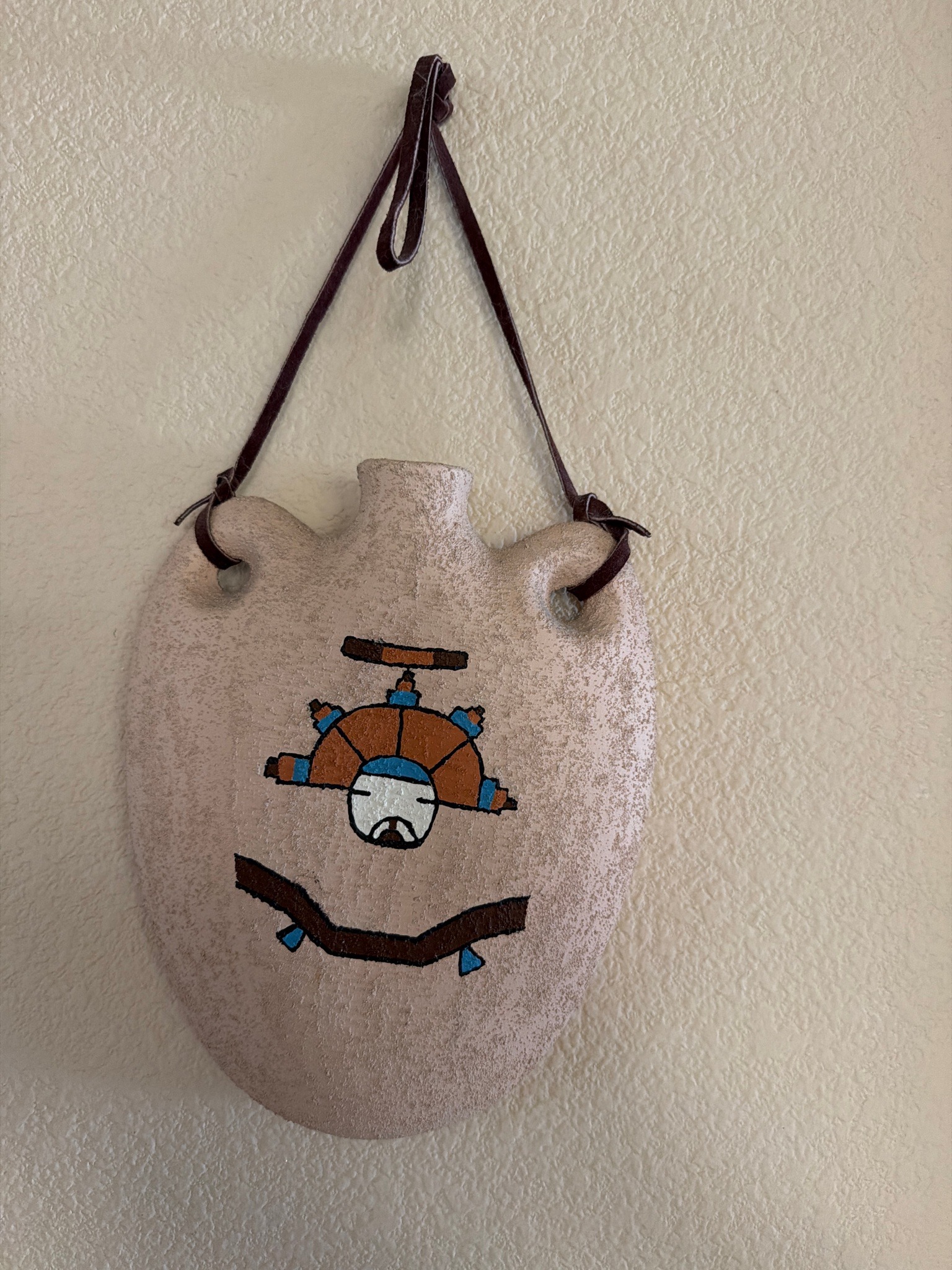 Submitted photo of Handmade ceramic canteen vessel with painted Native American style motifs