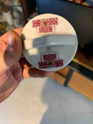 White Ceramic Lid with Red Stylized Floral Pattern and Bar Handle