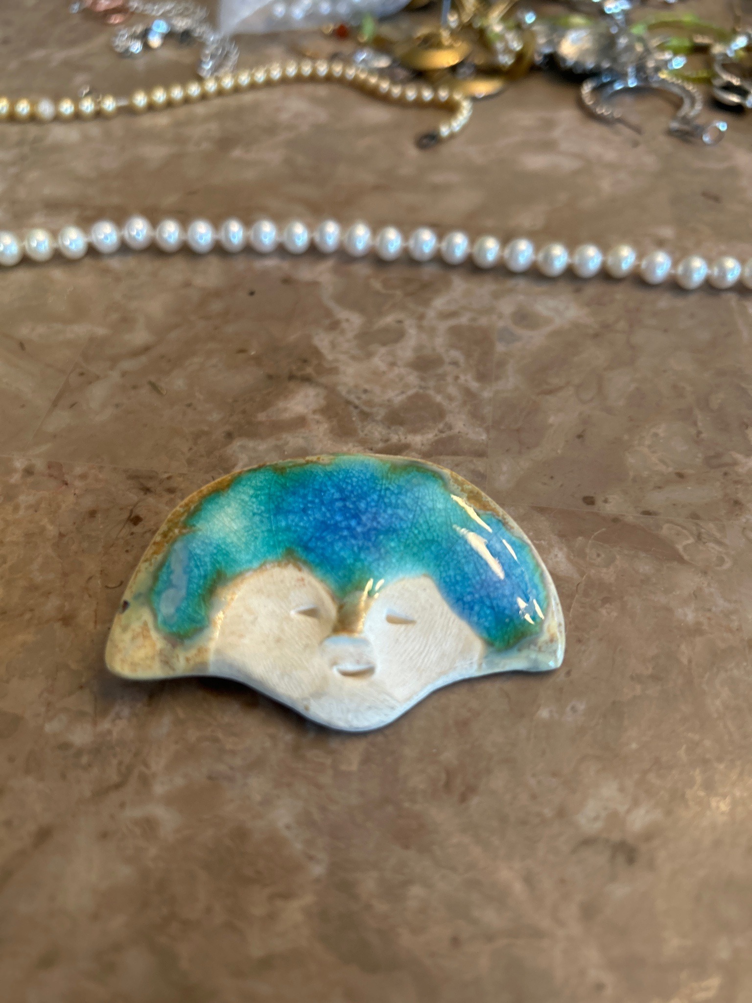 Submitted photo of Ceramic figural brooch, unverified maker