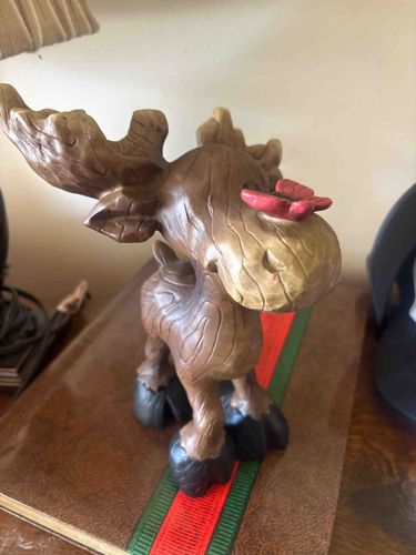 Carved Wooden Moose Figurine with Butterfly Accent