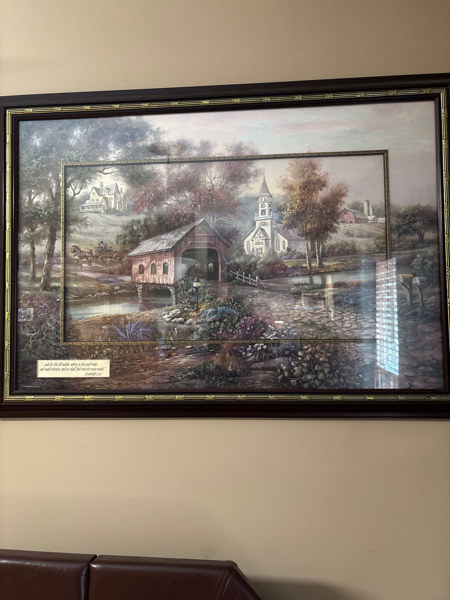 Submitted photo of Framed print depicting a pastoral landscape with a covered bridge
