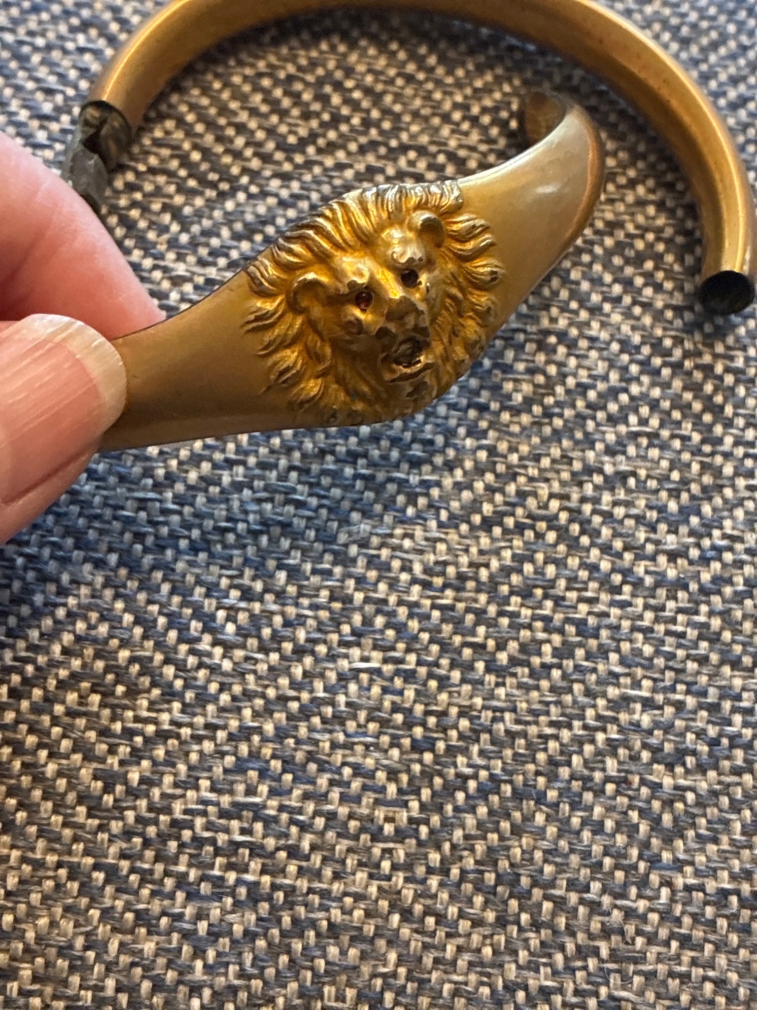 Submitted photo of Gold-toned metal hinged bangle bracelet with lion motif