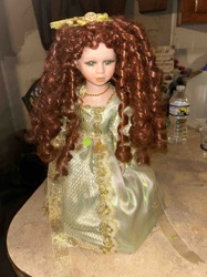 Porcelain/Bisque Collectible Doll with Reddish Curly Hair and Green Dress
