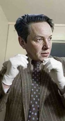 Portrait of a Man in a Pinstriped Suit with White Gloves