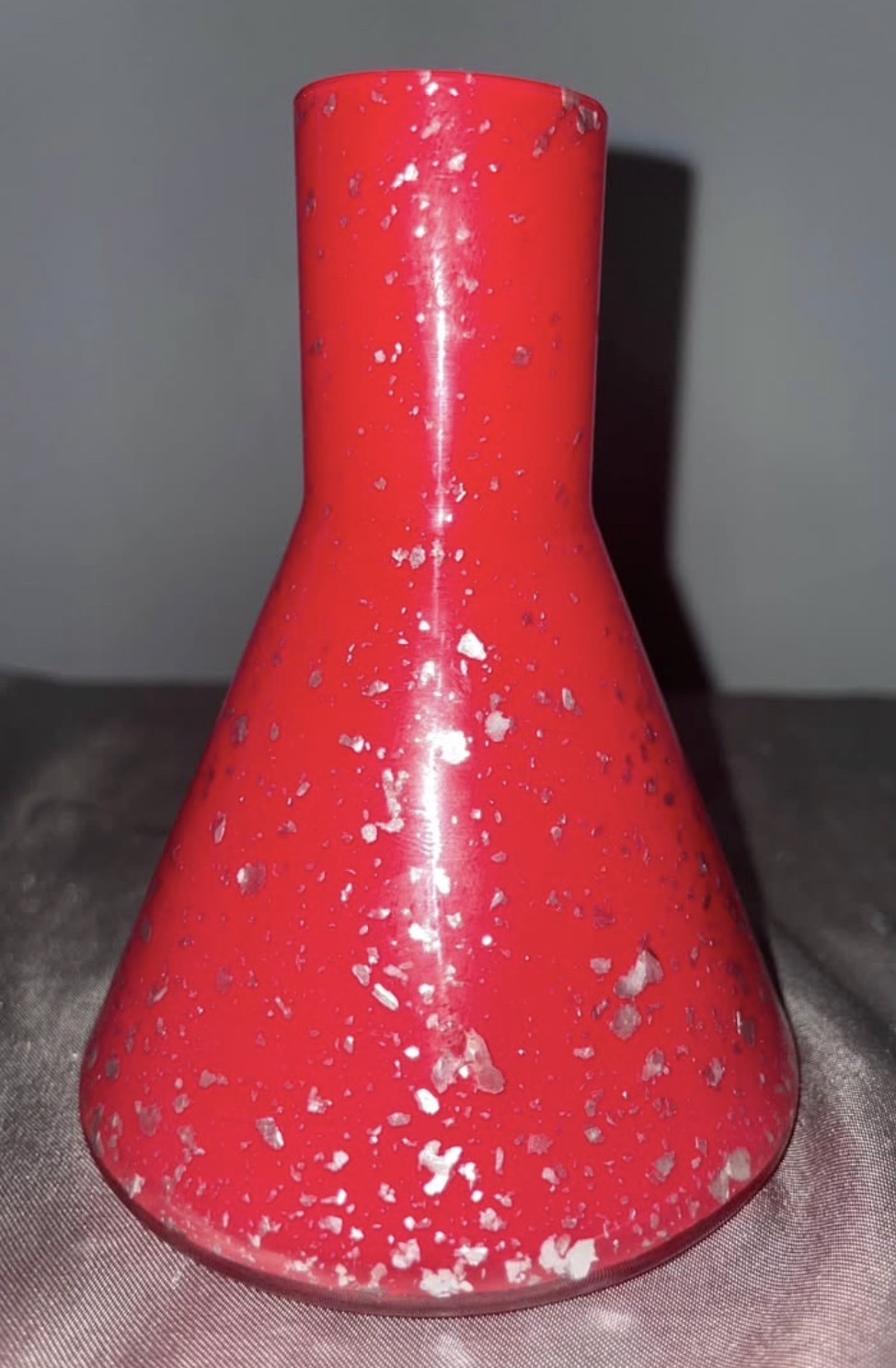 Submitted photo of Red glass bud vase with silver foil inclusions