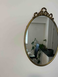 Vintage Oval Wall Mirror with Ornate Brass-Finished Crest