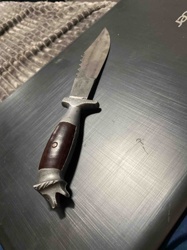 Fixed Blade Knife with Serrated Spine and Decorative Pommel