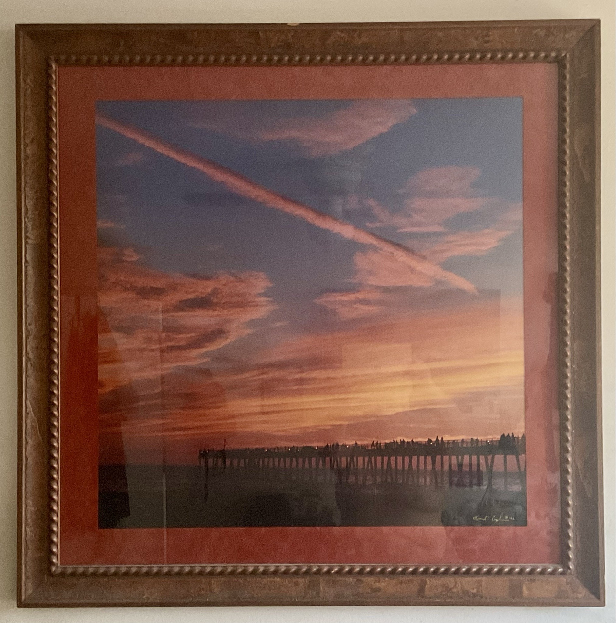 Submitted photo of Framed photographic print depicting a sunset and pier