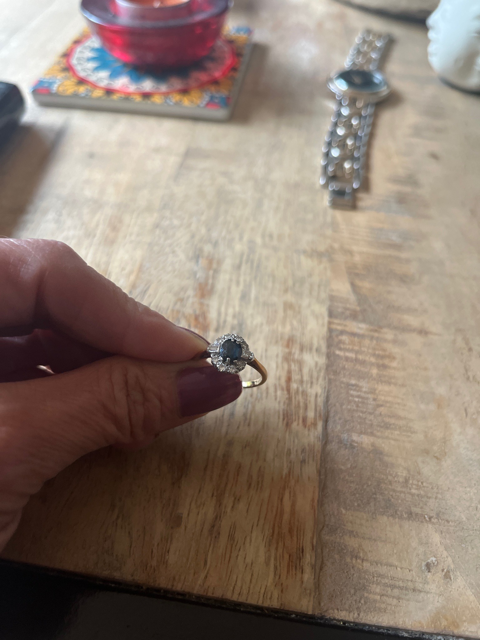 Submitted photo of Cluster ring with blue center stone and diamond halo
