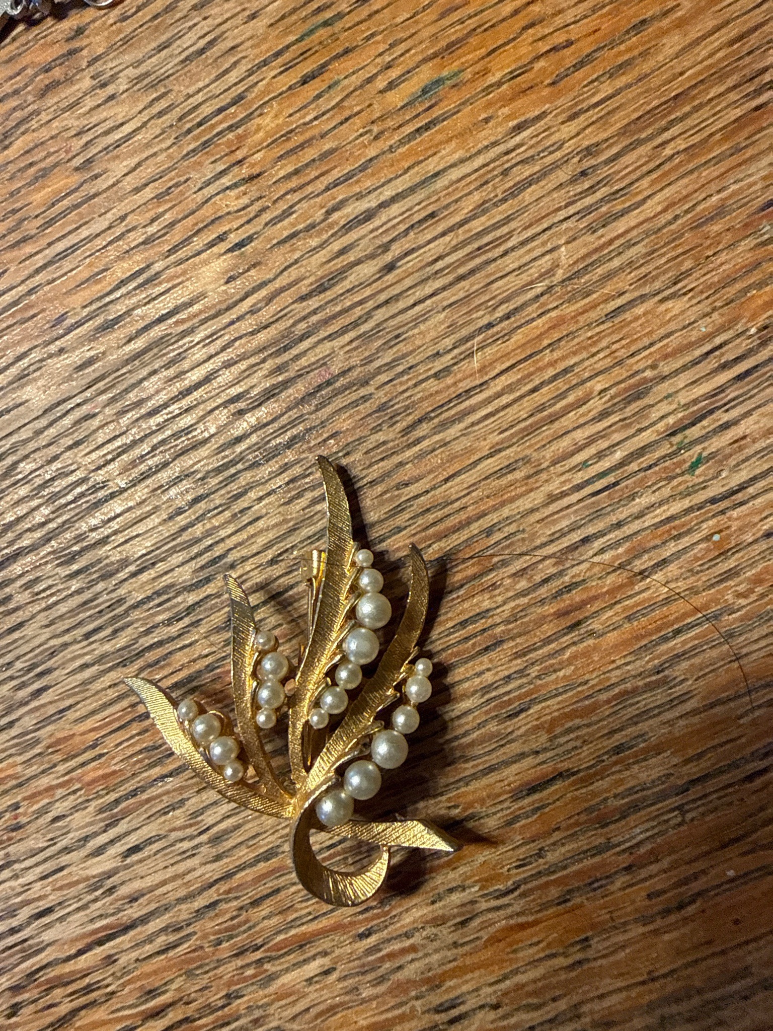 Submitted photo of Gold-tone floral spray brooch with faux pearls