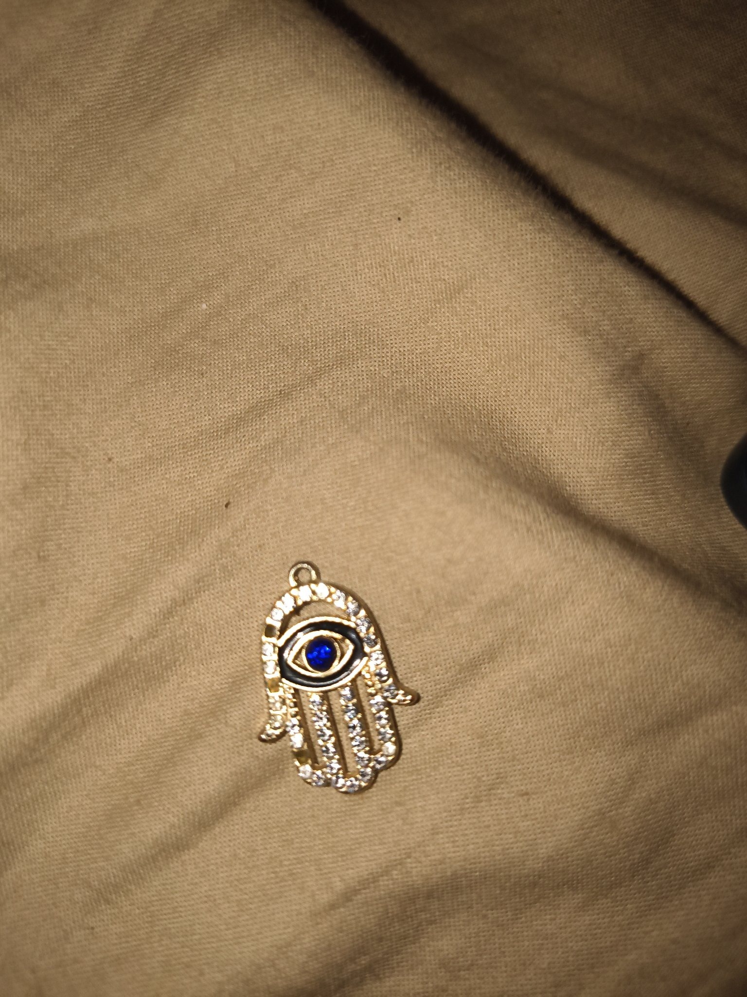 Submitted photo of Gold-tone Hamsa hand pendant