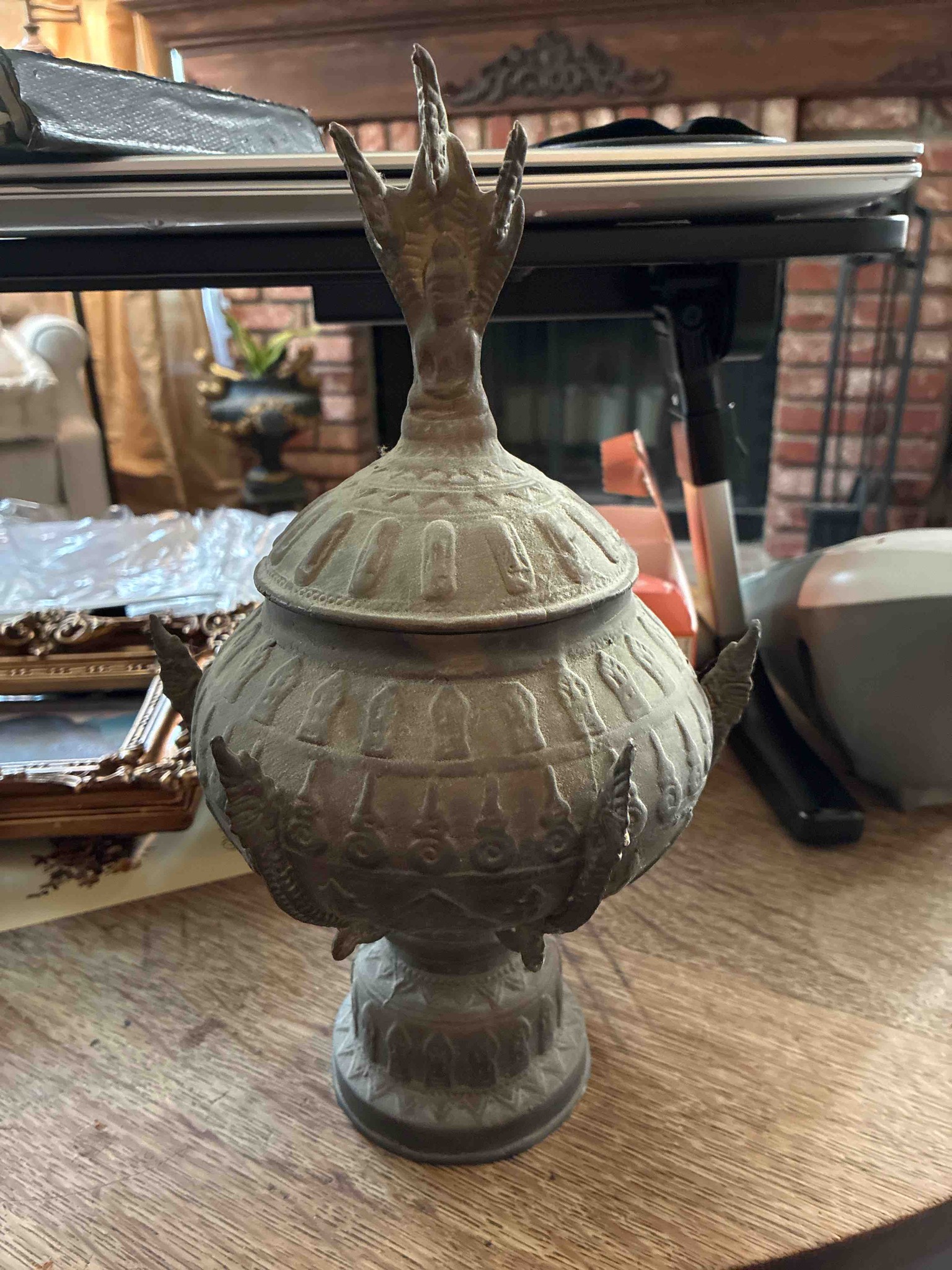 Submitted photo of Bronze covered urn with naga and Buddha imagery (unverified)