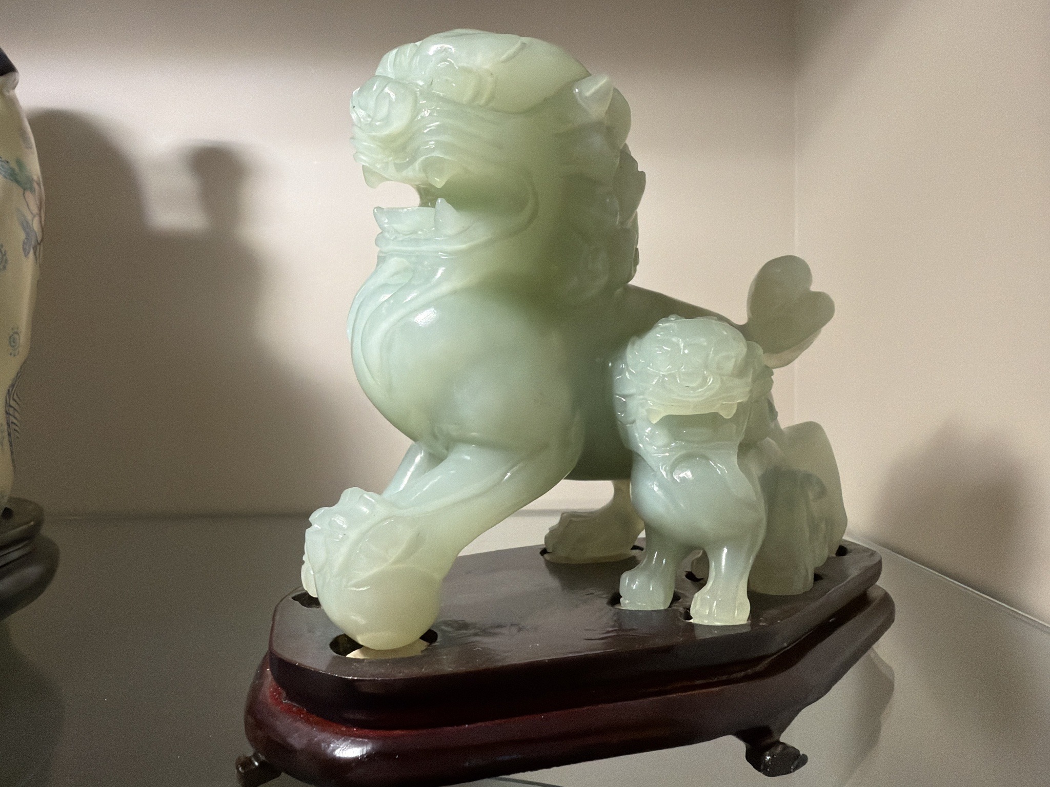 Submitted photo of Carved pale green stone Foo Dog sculpture with cub