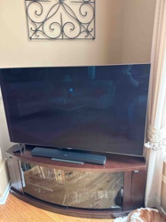 Samsung Television (Model nine) with Soundbar and Media Console