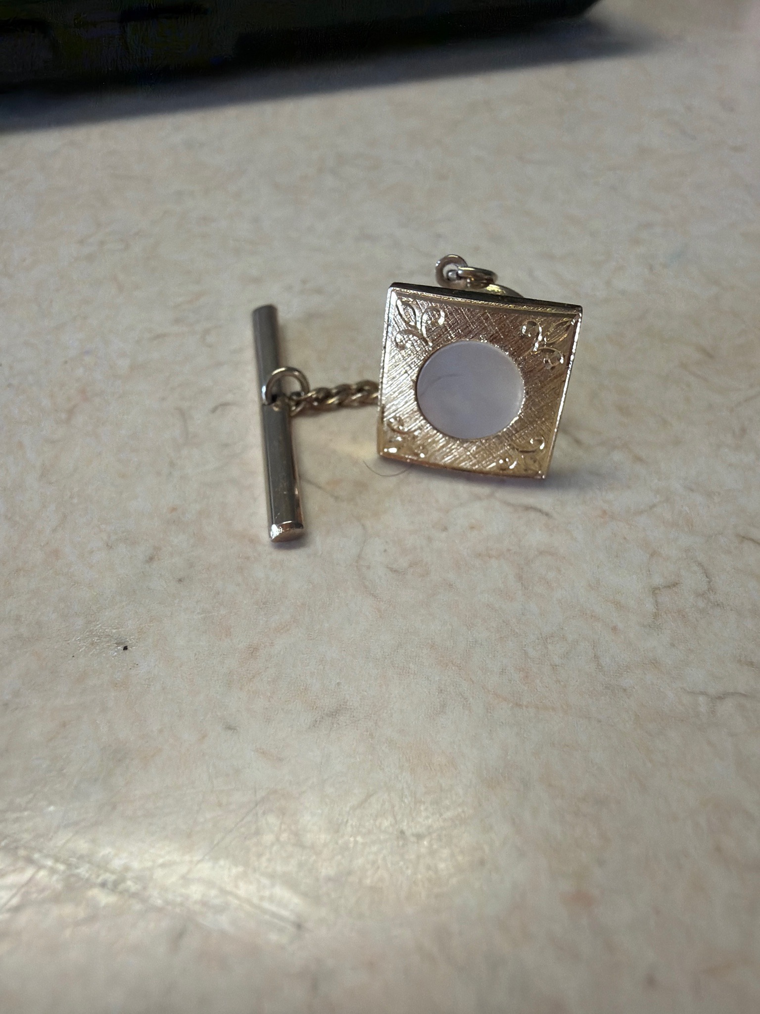 Submitted photo of Vintage-style gold-tone tie tack with mother-of-pearl inlay and T-bar chain