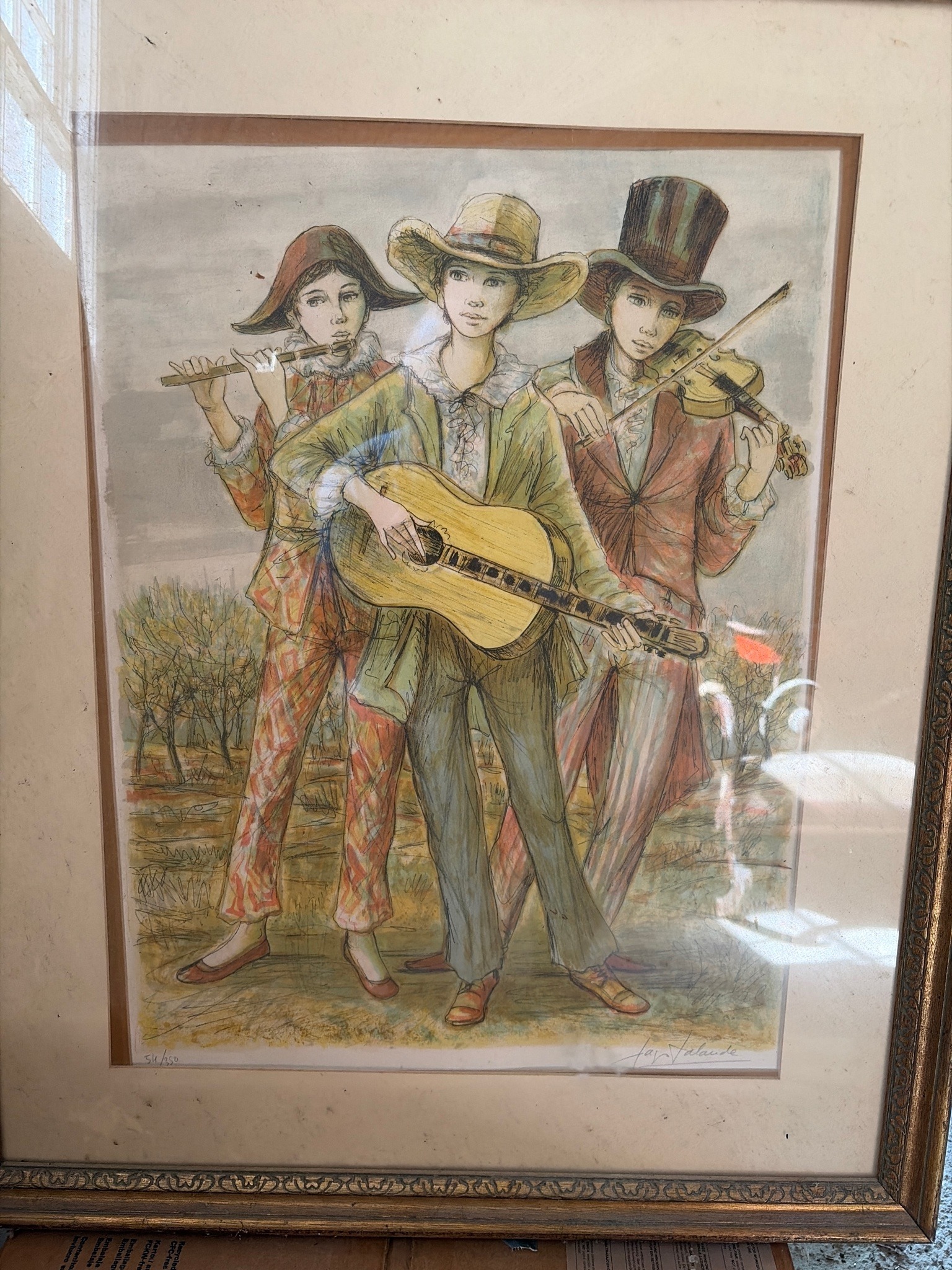 Submitted photo of Framed print featuring three musicians, signed 'Fay Lalande'
