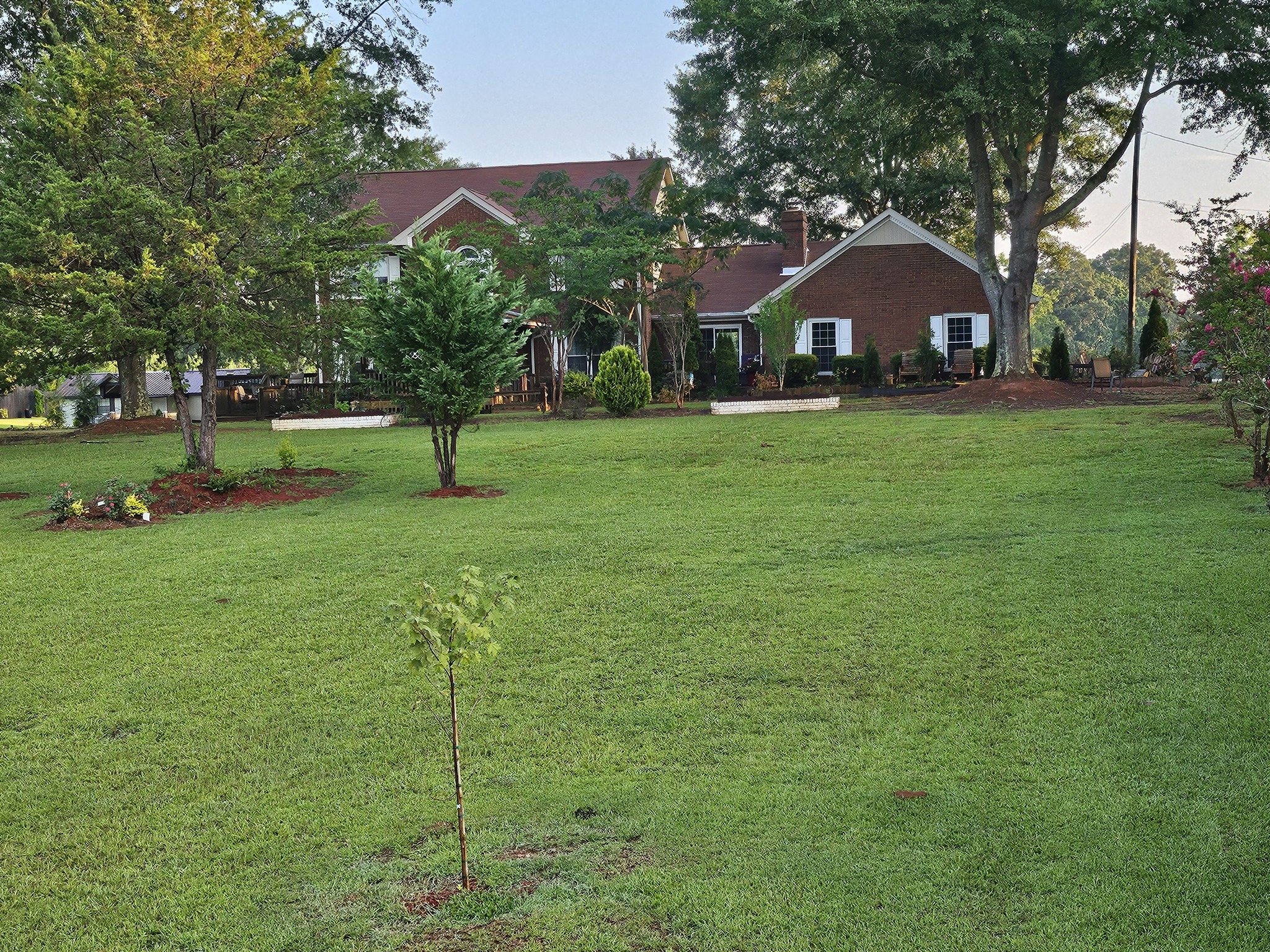 Submitted photo of Residential property with brick exterior and landscaped yard