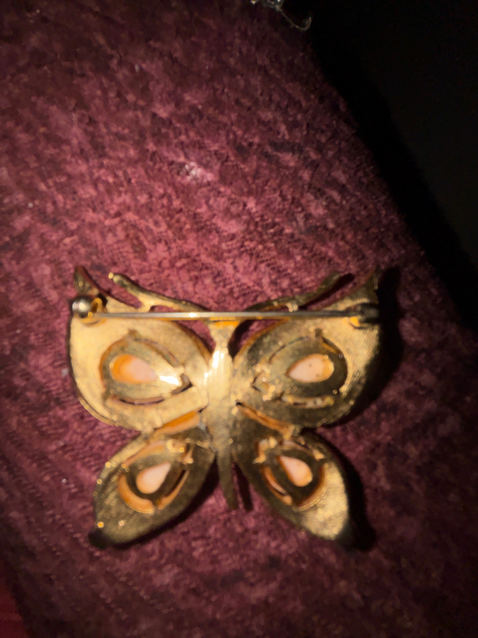 Submitted photo of Gold-tone metal and pink cabochon butterfly brooch