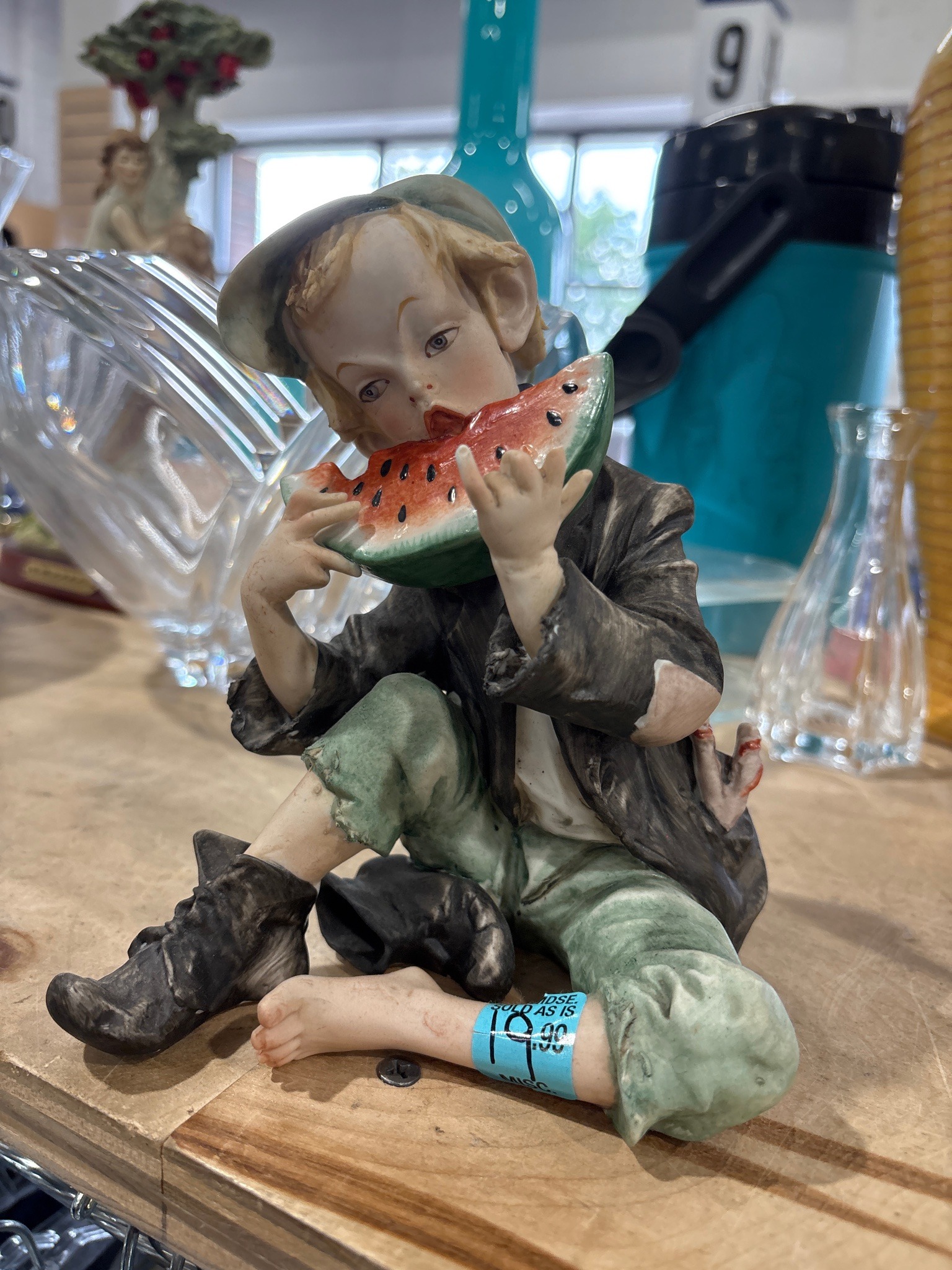 Submitted photo of Porcelain figurine of a boy eating watermelon (unauthenticated)