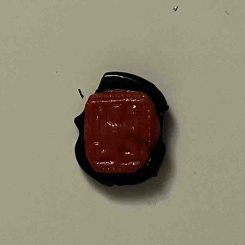 Red Wax Seal Impression on Dark Material