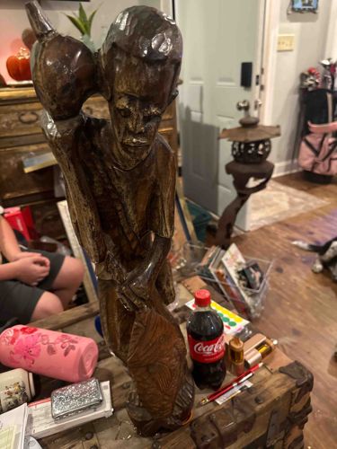 Carved Wooden Figure of a Man Carrying a Vessel (Water Carrier)