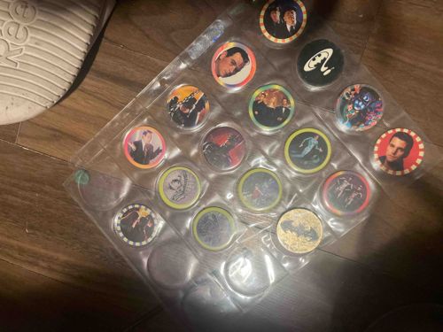 Collection of 1990s Movie/Superhero Themed Pogs in Collector's Page