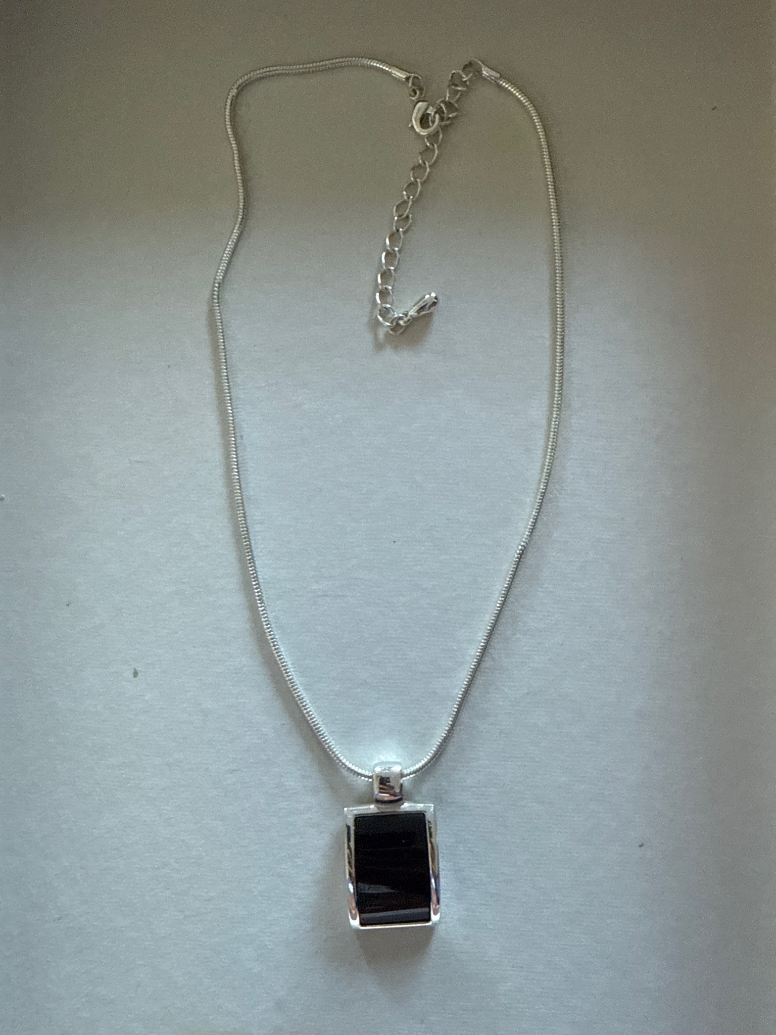Submitted photo of Silver-tone necklace with rectangular black stone pendant
